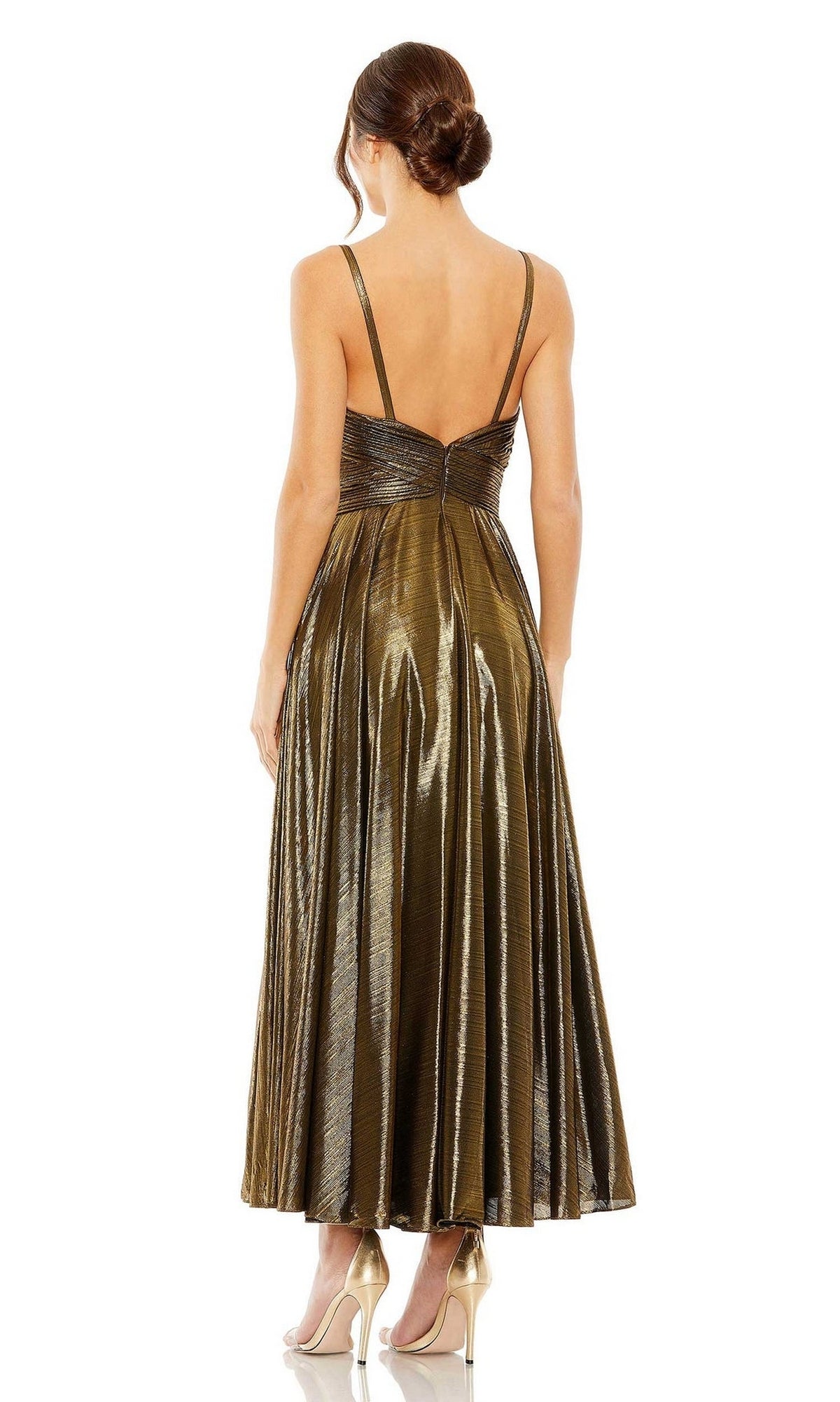 A woman faces away, wearing the Mac Duggal 30761 tea-length wedding-guest dress in metallic gold with thin straps and nude high heels.
